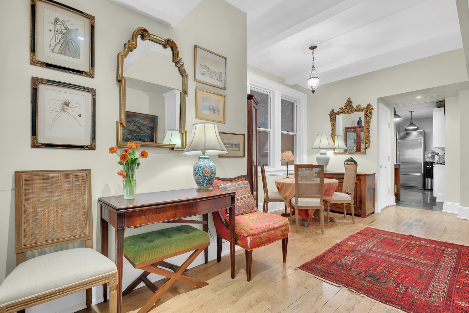 Undisclosed Address Manhattan, NY 10128 - Photo 3 of 9 a living room with furniture a table and paintings on the wall