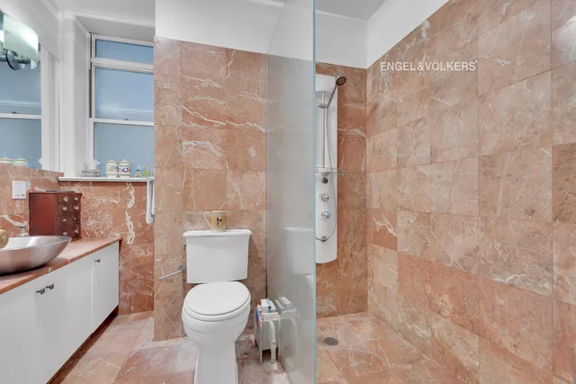 a bathroom with a toilet sink and shower