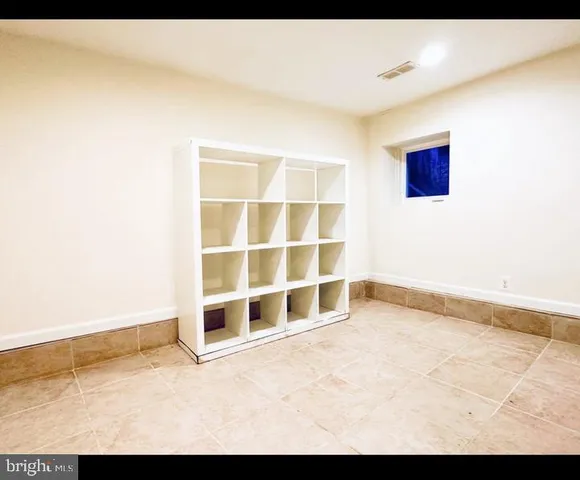 a view of a house with a small yard and wooden fence
