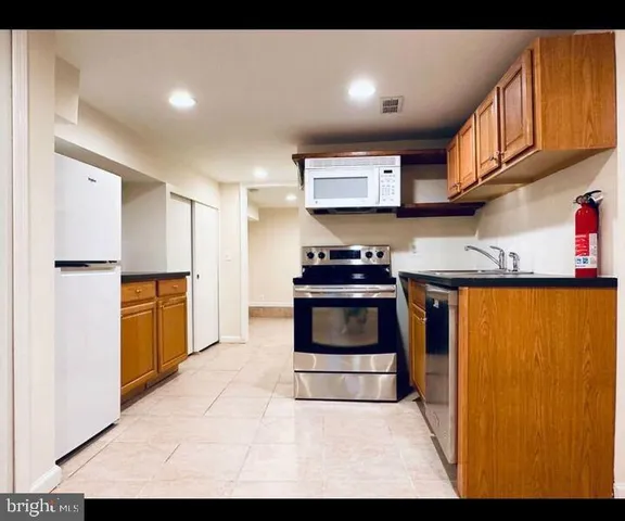 a kitchen with stainless steel appliances granite countertop a refrigerator sink and stove