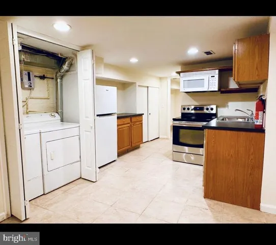 a view of kitchen with refrigerator and window