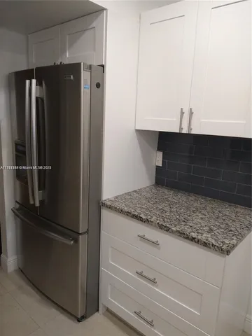 a kitchen with appliances and cabinets