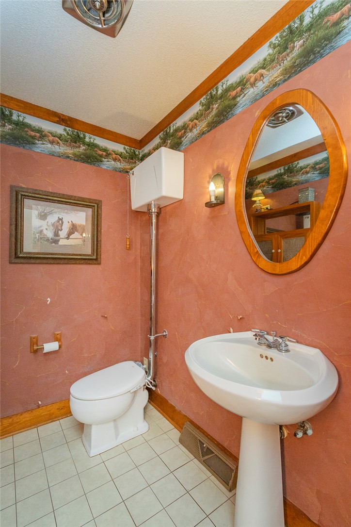 911 State Rd S-4-203 Belton, SC 29627 - Photo 17 of 49 Functional full bathroom featuring a pedestal sink and classic tiled floor.