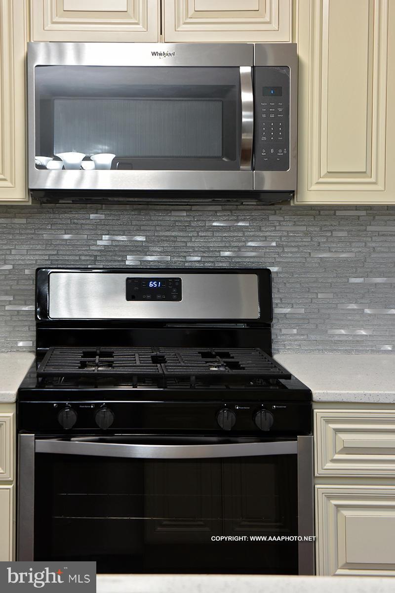 417 Grovethorn Road Middle River, MD 21220 - Photo 6 of 12 a kitchen with granite countertop cabinets and black appliances