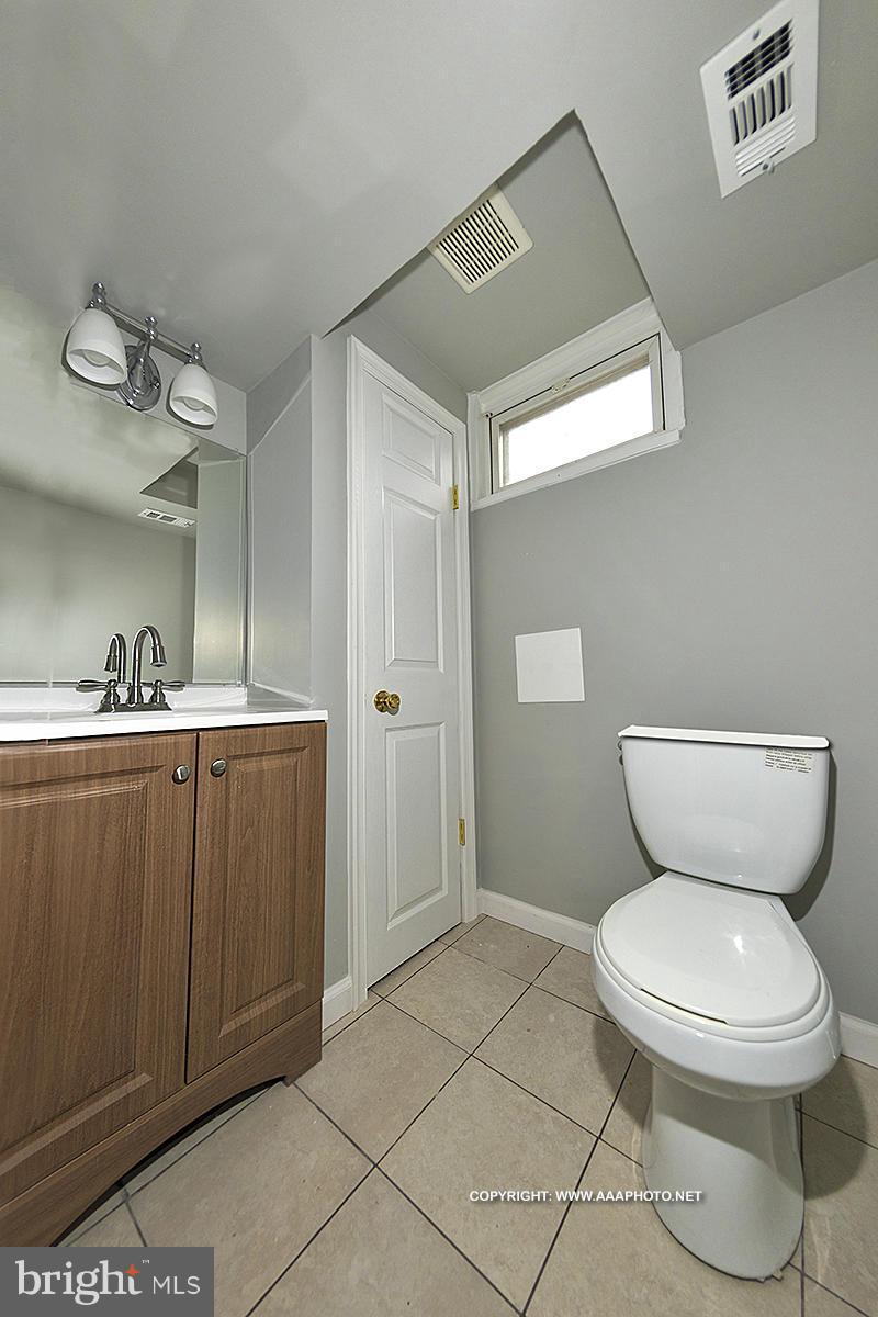 417 Grovethorn Road Middle River, MD 21220 - Photo 8 of 12 a bathroom with a toilet sink and mirror