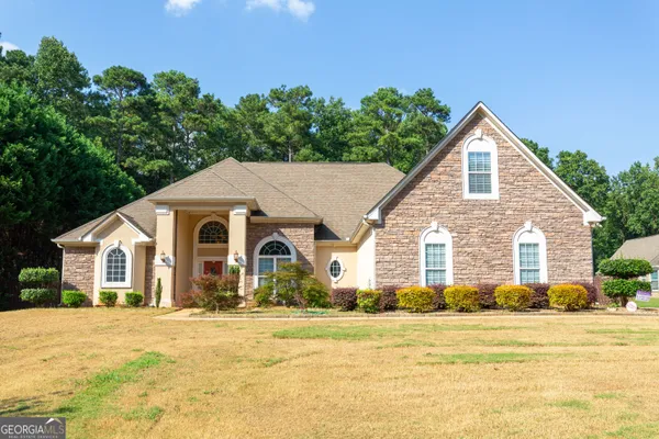 a front view of a house with a yard