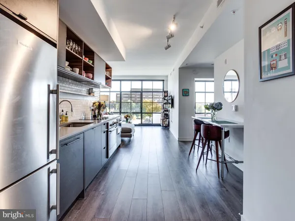 a kitchen with granite countertop lots of counter top space and wooden floor