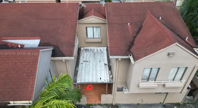 an aerial view of a house with a yard