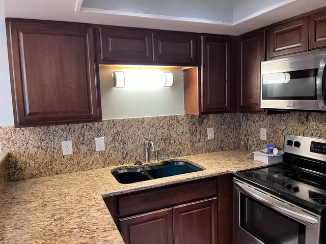 a kitchen with a sink and cabinets