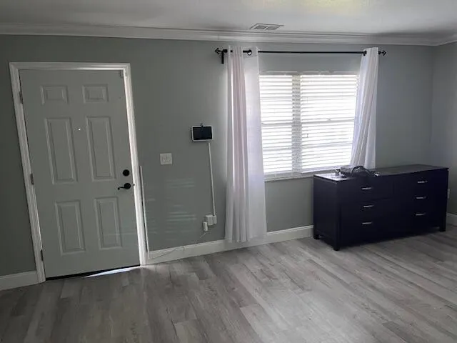 a room with a window and a dresser