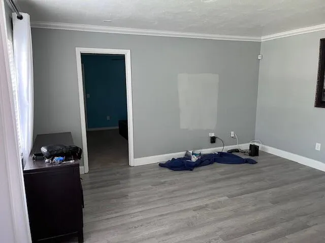 a room with wooden floor and shoes