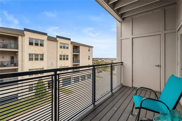 a view of a balcony with furniture and wooden floor