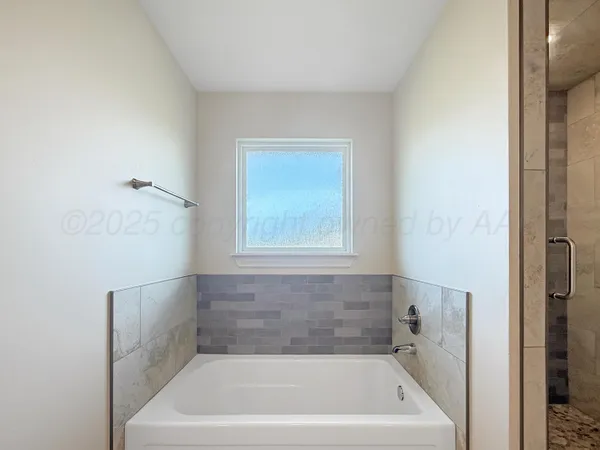 a bath tub sitting next to a white sink