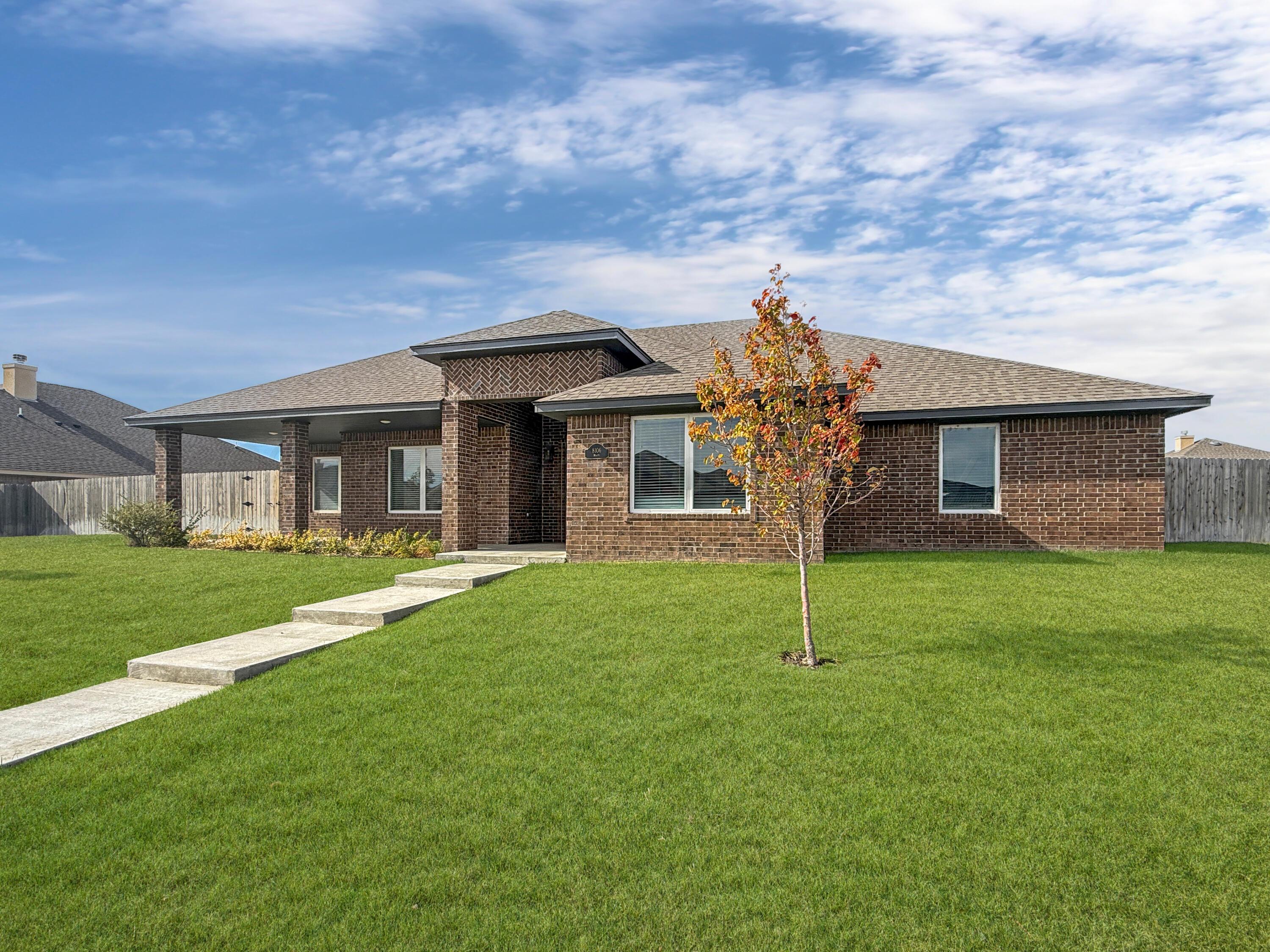 8106 Miami Avenue Amarillo, TX 79118 - Photo 2 of 19 a front view of a house with a garden