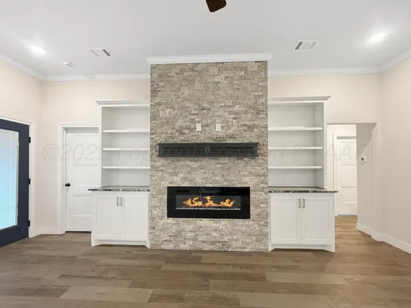 a living room with a fireplace and a wooden floor