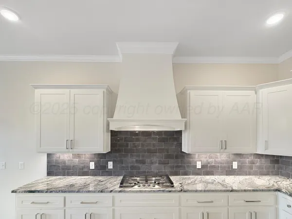 a kitchen with granite countertop a sink and a stove