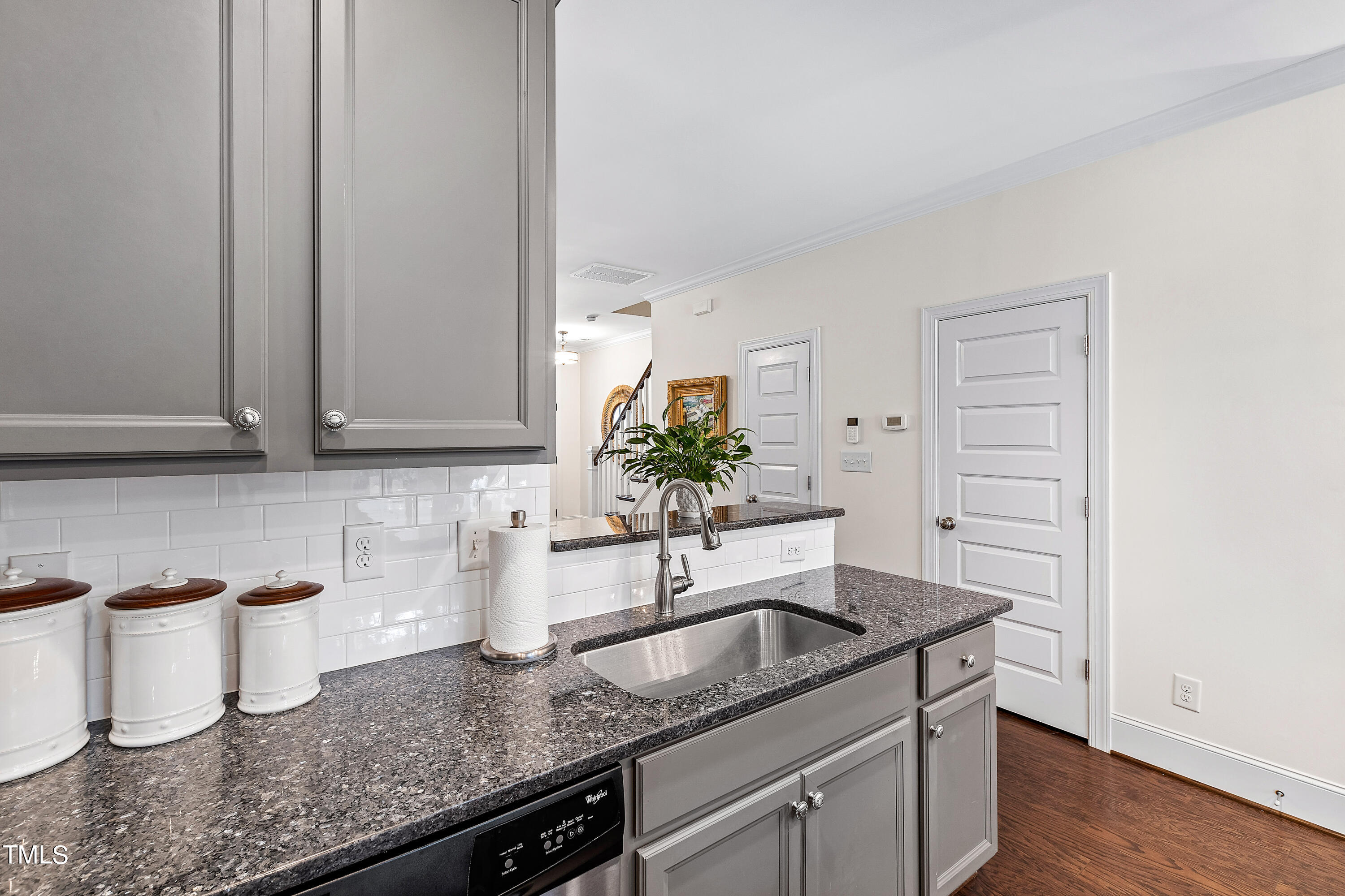 525 Ledbetter Court Raleigh, NC 27608 - Photo 16 of 45 a kitchen with granite countertop a sink and cabinets