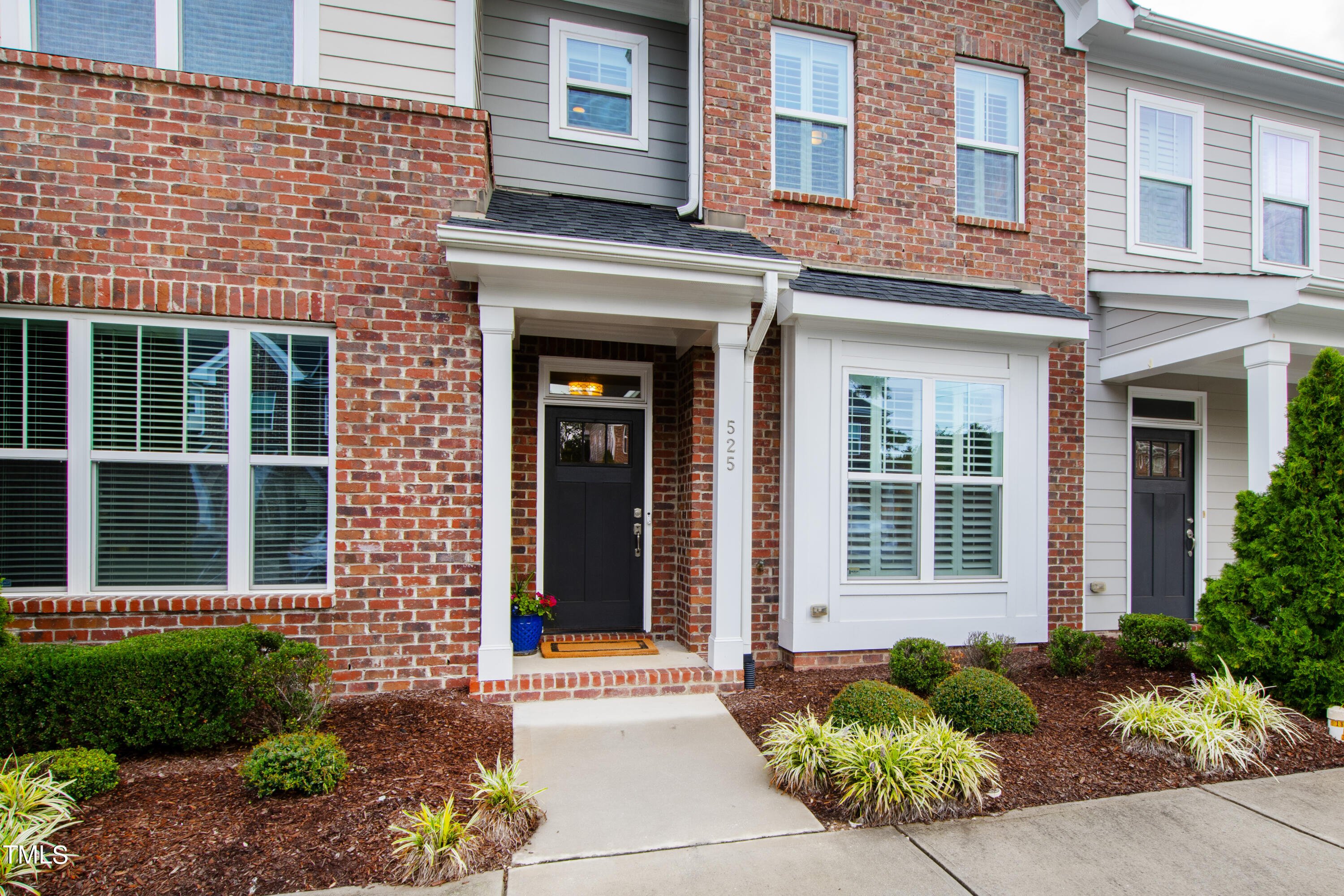 525 Ledbetter Court Raleigh, NC 27608 - Photo 2 of 45 a front view of a brick house many windows and plants