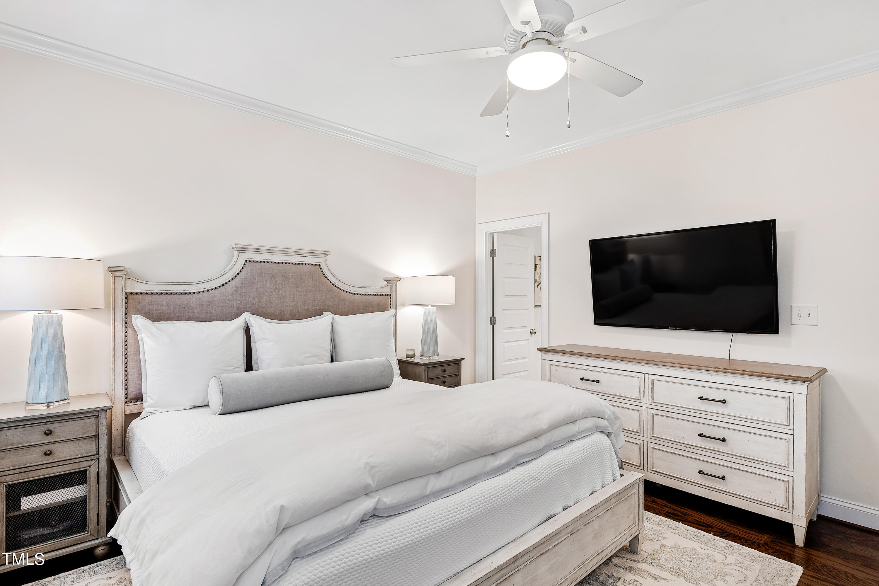 525 Ledbetter Court Raleigh, NC 27608 - Photo 25 of 45 a bedroom with a bed a flat tv screen and a chandelier