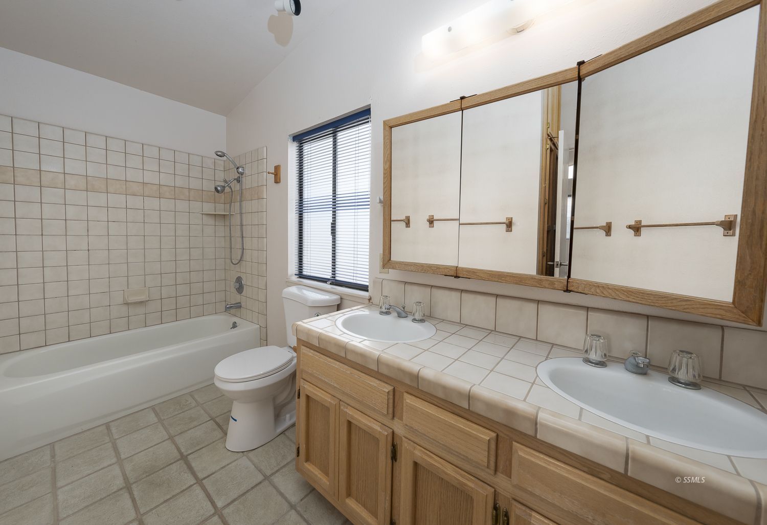 854 Campbell Street Ridgecrest, CA 93555 - Photo 23 of 45 a bathroom with a double vanity sink toilet mirror and bathtub