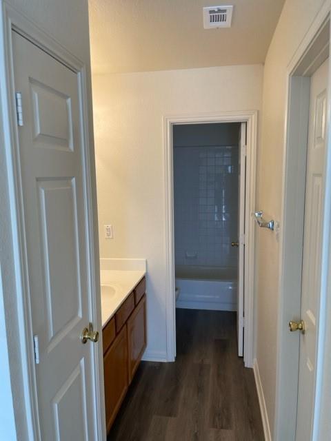 12403 Turtle Rock Road, Unit A Austin, TX 78729 - Photo 11 of 14 Functional full bathroom featuring a long vanity and a combined shower-tub.