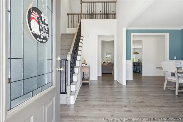 a view of an entryway with wooden floor and door