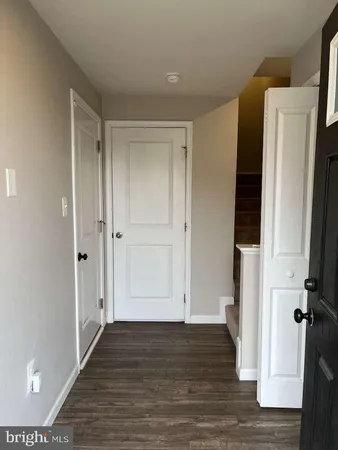 a view of hallway with wooden floor