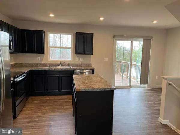 a kitchen with a sink and a stove top oven