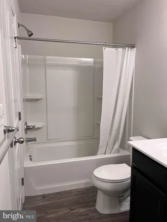 a view of a hallway with closet and bathroom