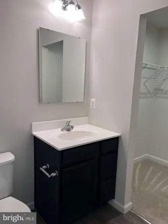 an empty room with closet and wooden door