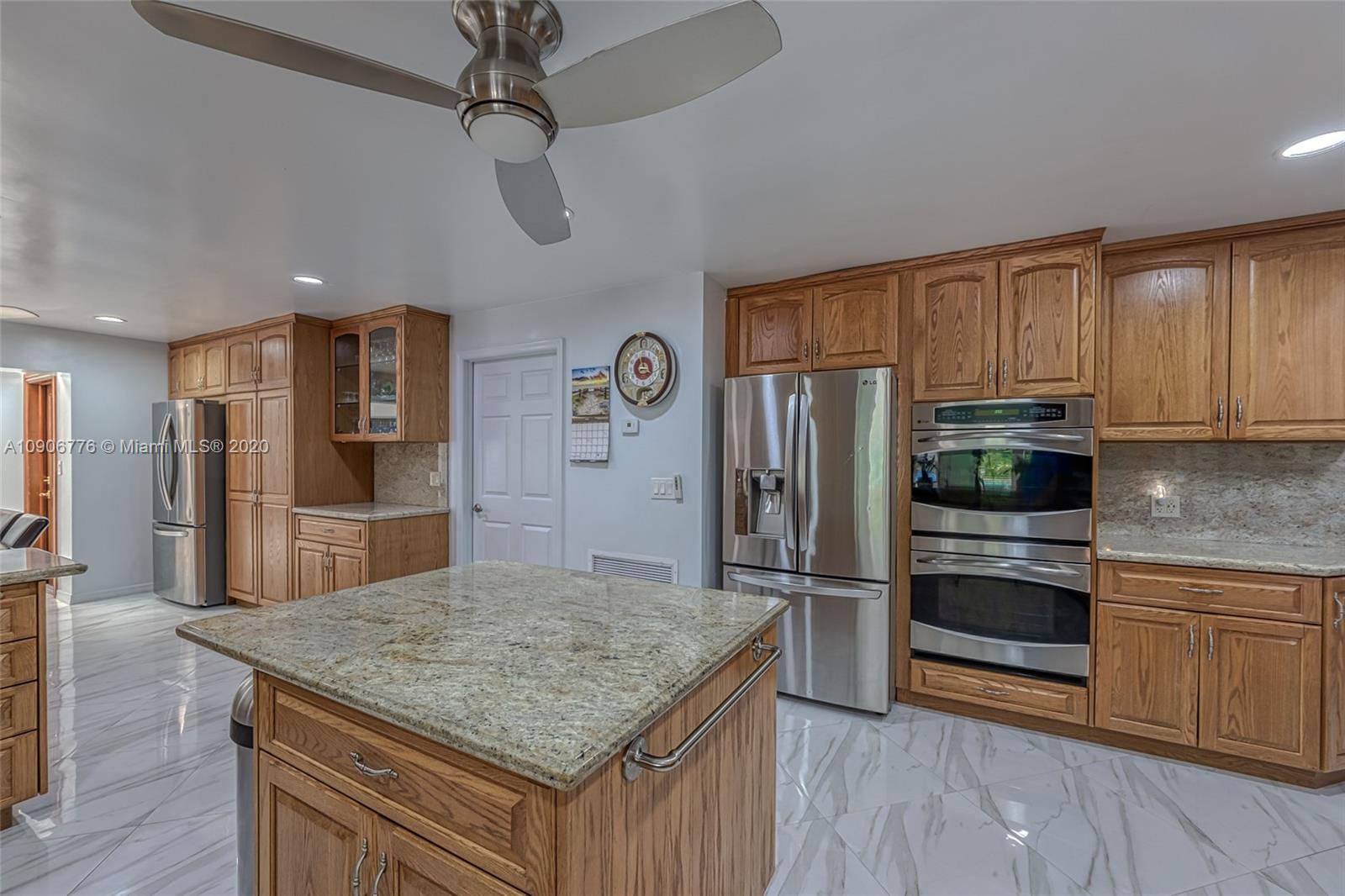 4860 Southwest 193rd Lane Southwest Ranches, FL 33332 - Photo 28 of 80 a kitchen with stainless steel appliances granite countertop a refrigerator a stove and a sink