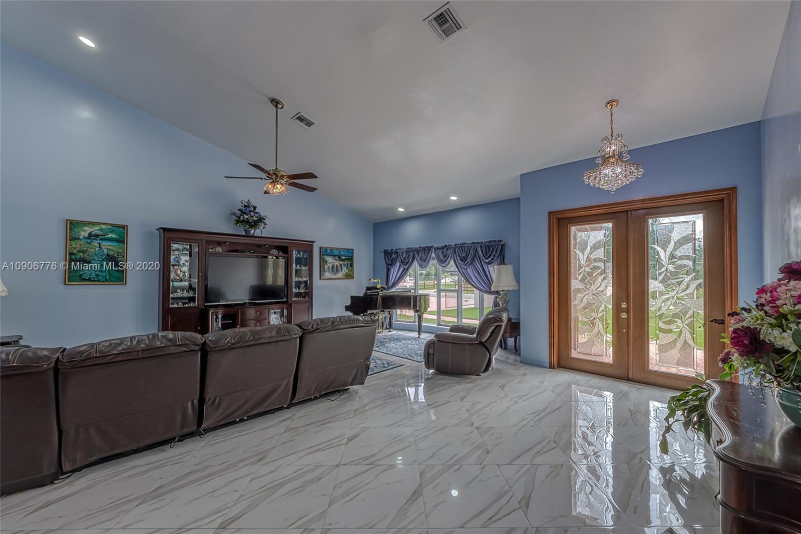4860 Southwest 193rd Lane Southwest Ranches, FL 33332 - Photo 38 of 80 a living room with furniture and a flat screen tv