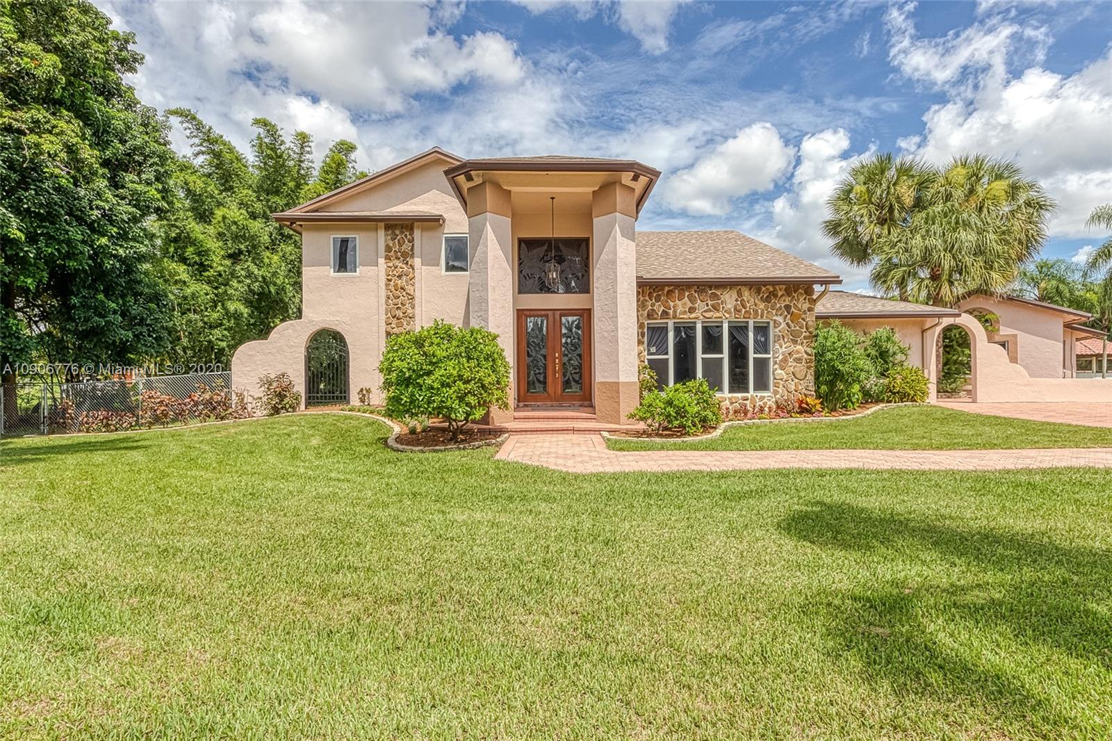 4860 Southwest 193rd Lane Southwest Ranches, FL 33332 - Photo 4 of 80 a front view of a house with a yard