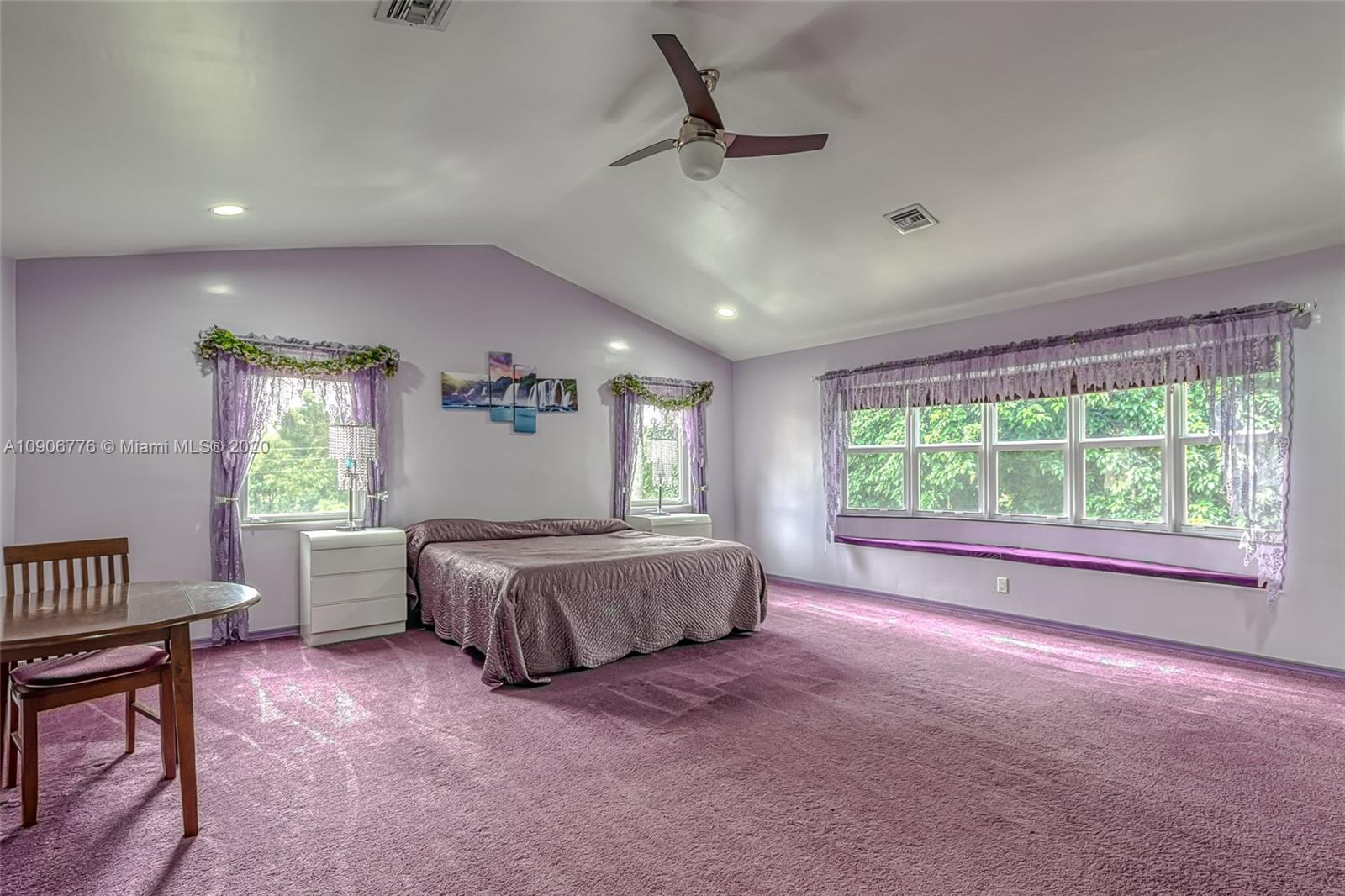 4860 Southwest 193rd Lane Southwest Ranches, FL 33332 - Photo 41 of 80 a spacious bedroom with a large bed and a chandelier