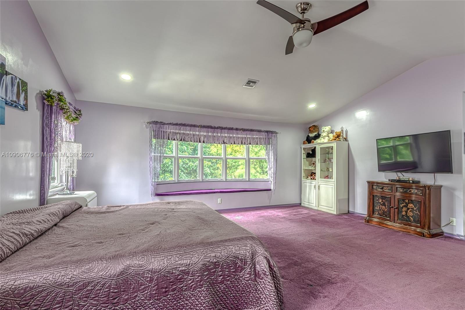 4860 Southwest 193rd Lane Southwest Ranches, FL 33332 - Photo 43 of 80 a spacious bedroom with a large bed and a flat screen tv