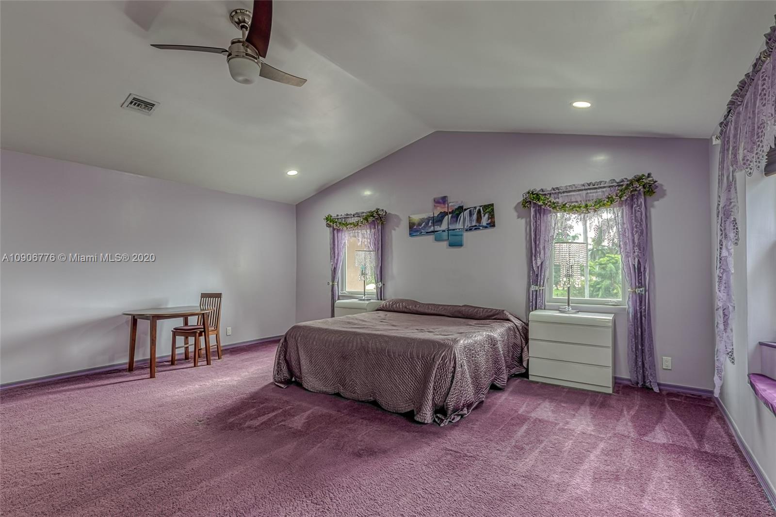 4860 Southwest 193rd Lane Southwest Ranches, FL 33332 - Photo 44 of 80 a spacious bedroom with a bed and a table in it