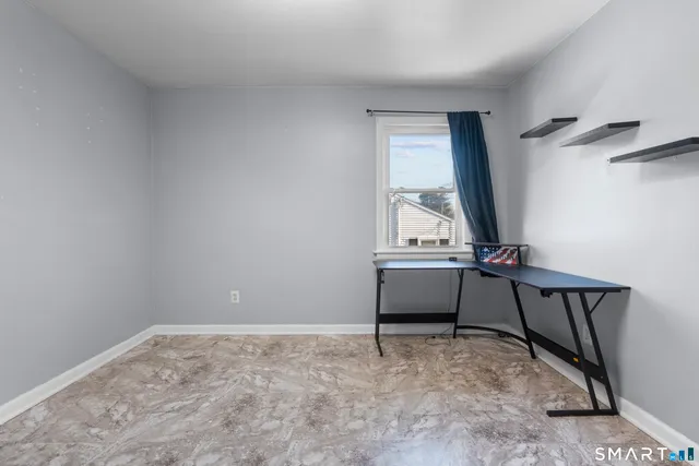 a bedroom with bed and a window