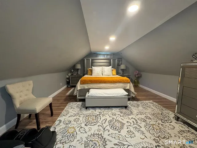a view of empty room with wooden floor and fireplace