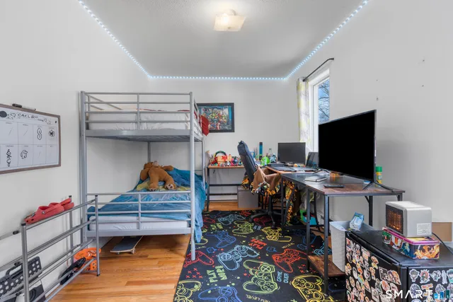 a bedroom with a bed and flat screen tv