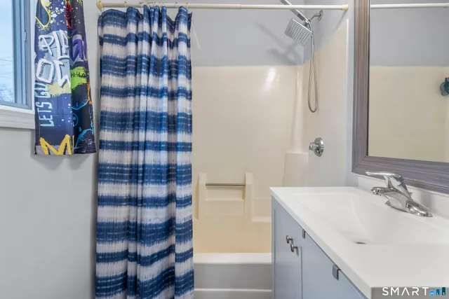 a living room with furniture a flower pot and a fireplace