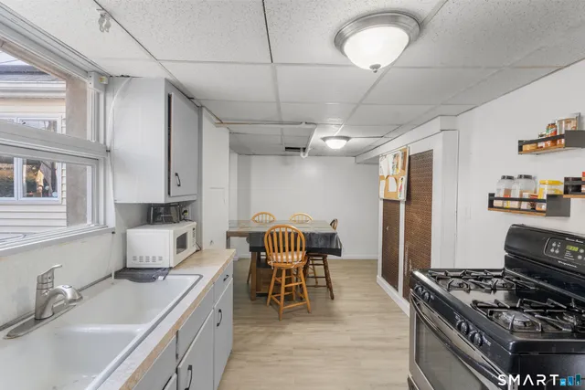 a kitchen with stainless steel appliances granite countertop a refrigerator and a stove