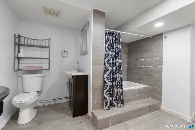 a bathroom with a bathtub a sink and a shower