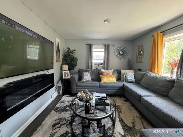a living room with furniture and a flat screen tv