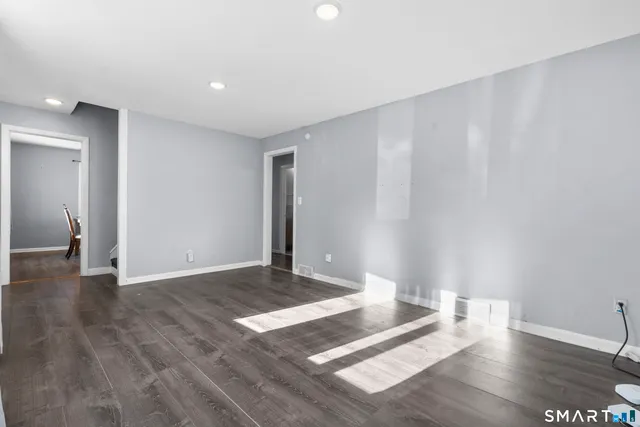 a view of an empty room and wooden floor