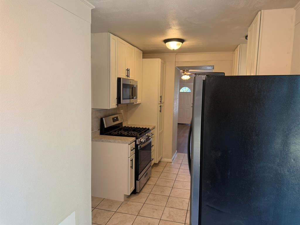 625 South Andrews Avenue Sherman, TX 75090 - Photo 15 of 17 a kitchen with stainless steel appliances granite countertop a refrigerator and a stove