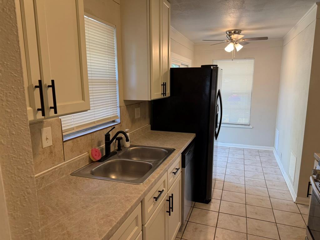 625 South Andrews Avenue Sherman, TX 75090 - Photo 16 of 17 a kitchen with a sink a refrigerator and cabinets