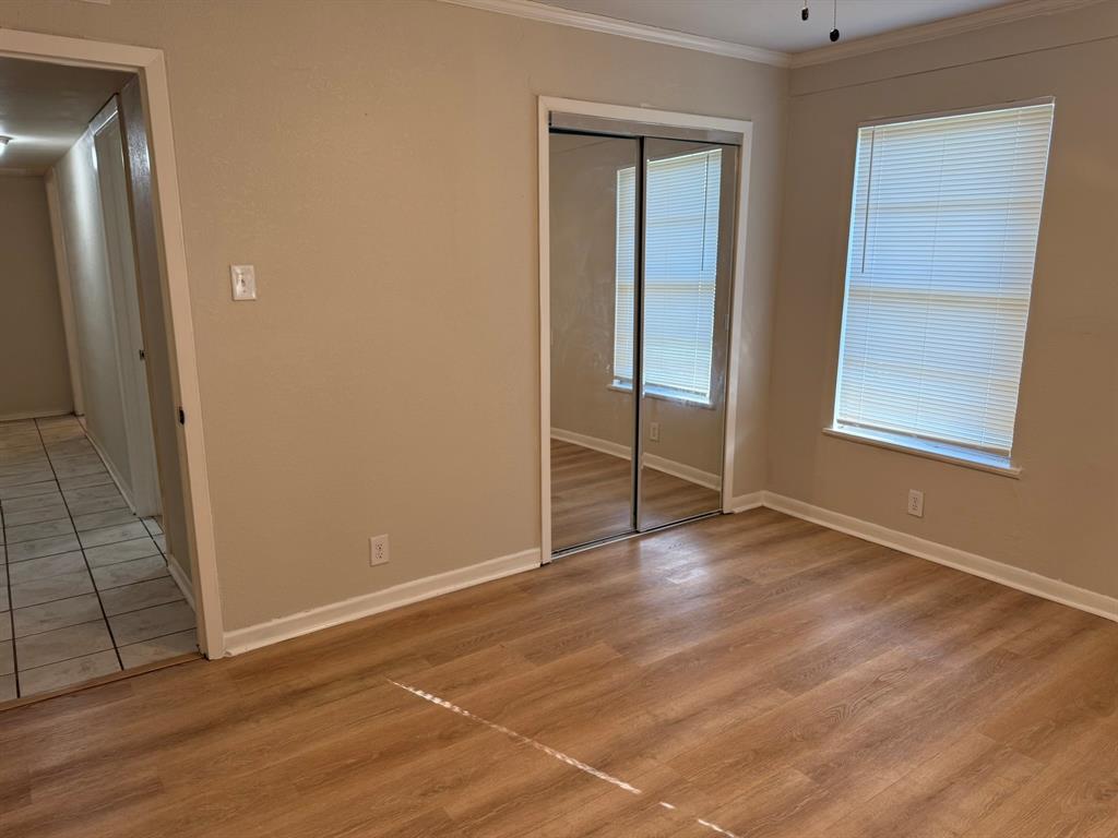 625 South Andrews Avenue Sherman, TX 75090 - Photo 5 of 17 an empty room with wooden floor and windows