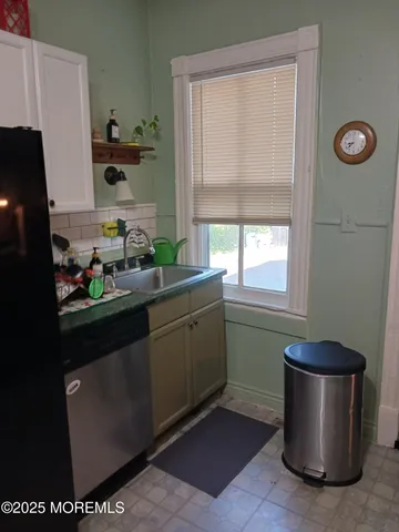 a kitchen with a sink and cabinets