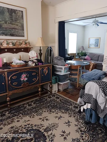 a living room with furniture a rug and wall painting