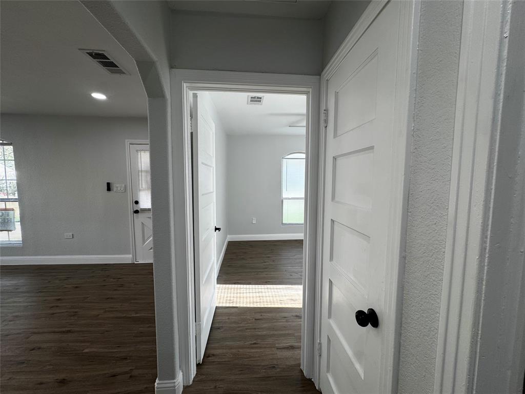 2909 Alexander Avenue Waco, TX 76708 - Photo 16 of 27 Corridor featuring dark wood-type flooring, plenty of natural light, arched walkways, and recessed lighting